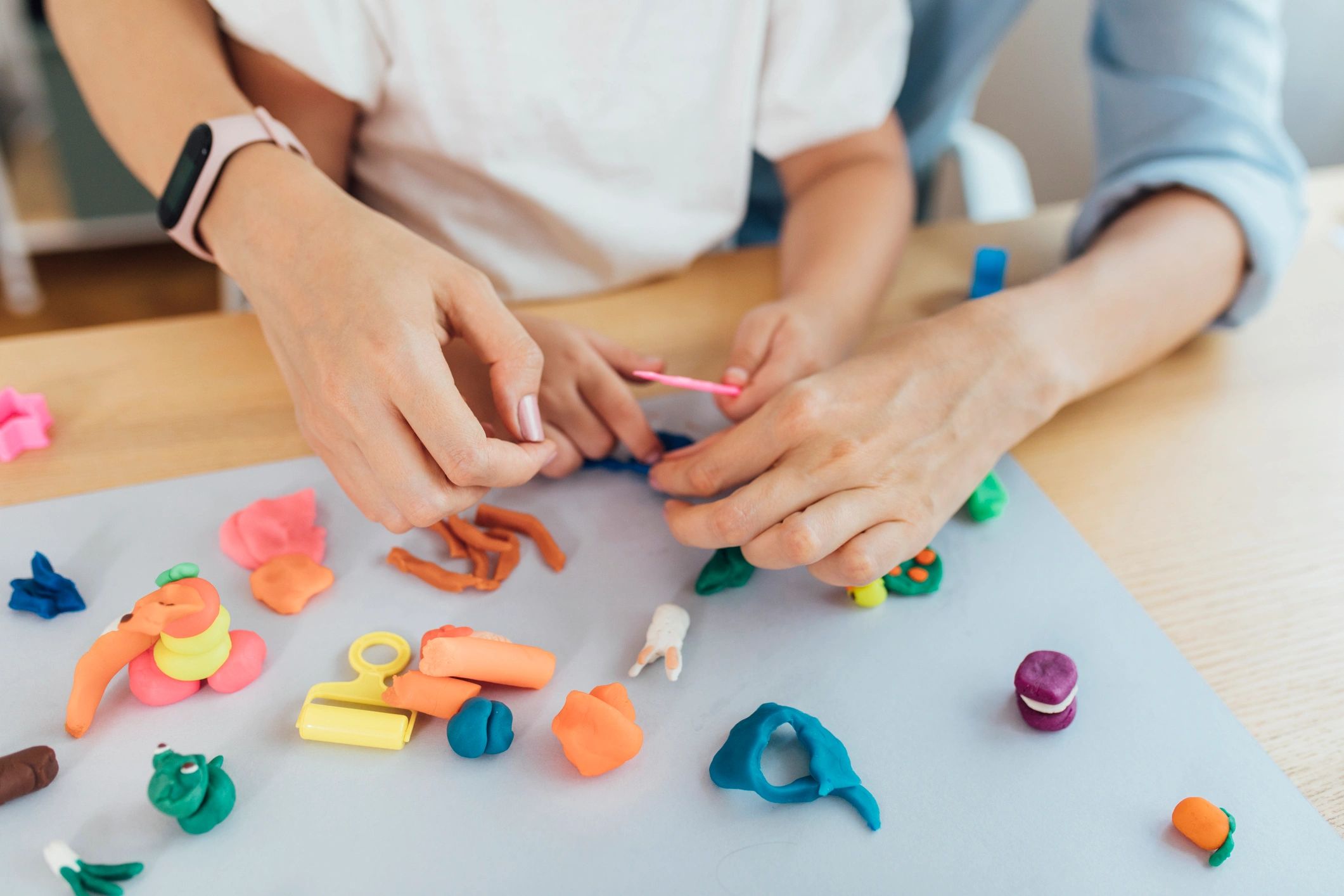 Hands shaping colorful clay during a craft activity