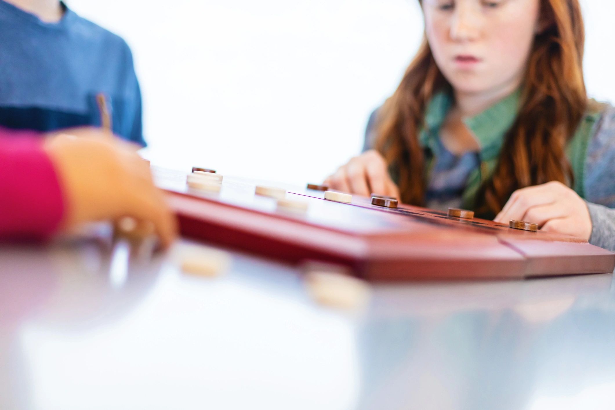 Children playing checkers at a table