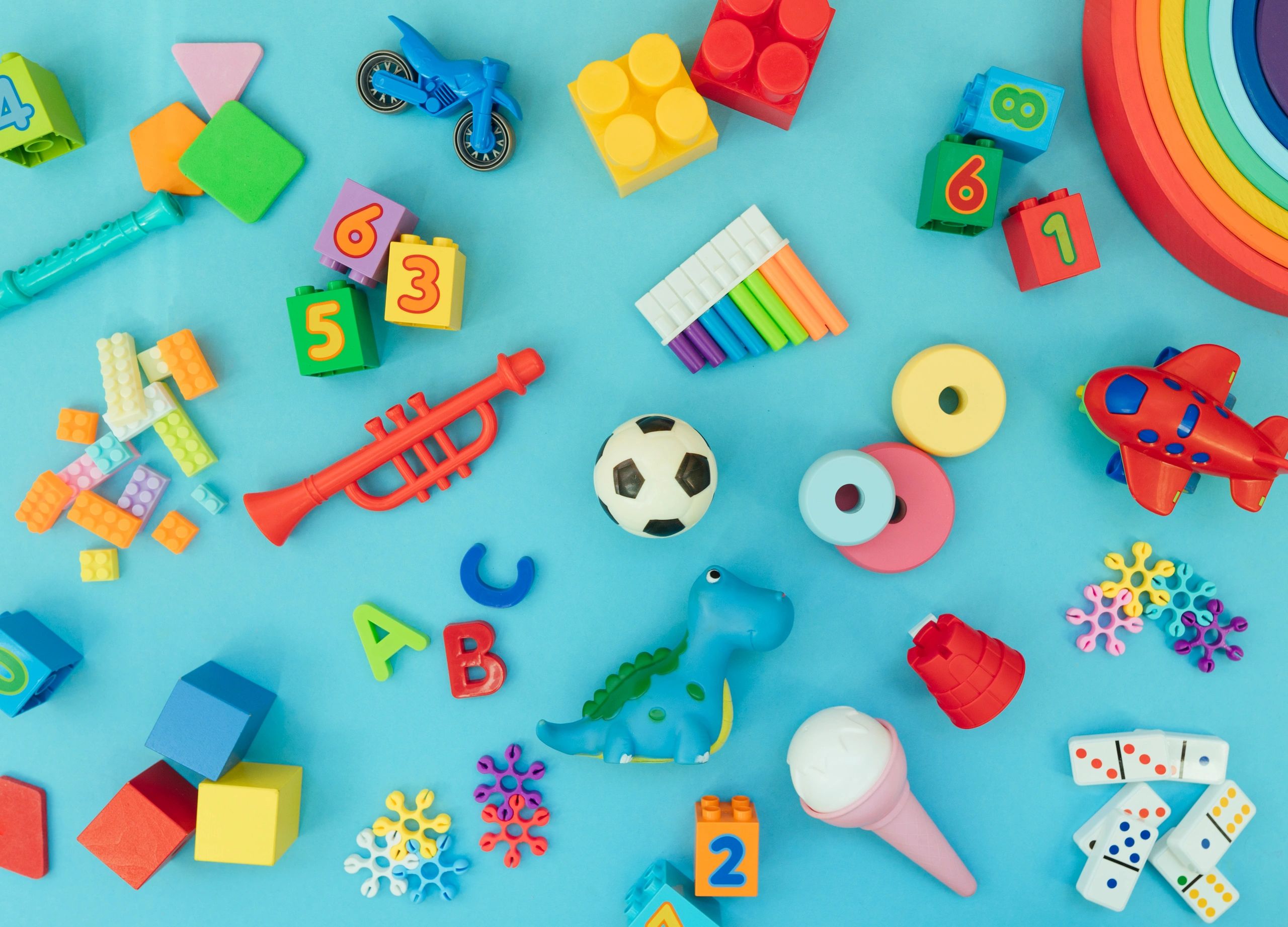 Assorted kids toys on a blue background with copy space