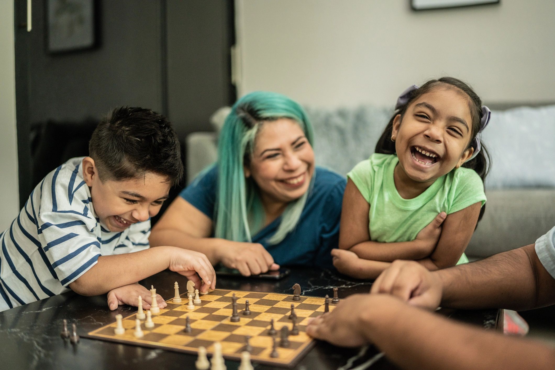 Family playing chess together at home