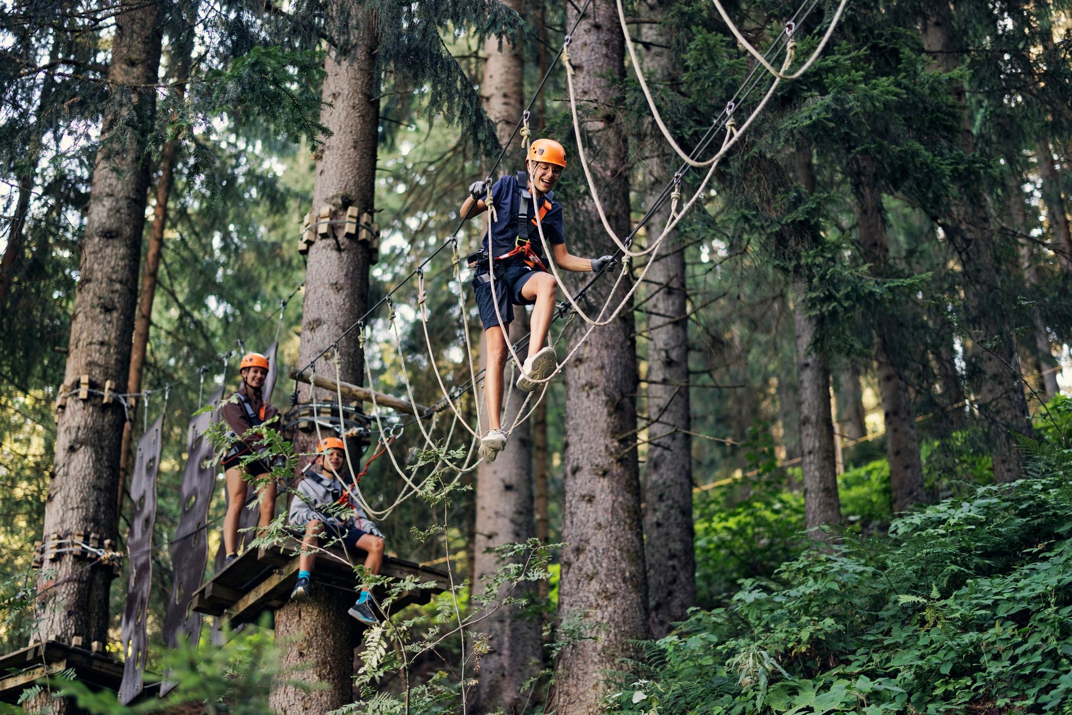 Kids navigating a ropes course obstacle outdoors