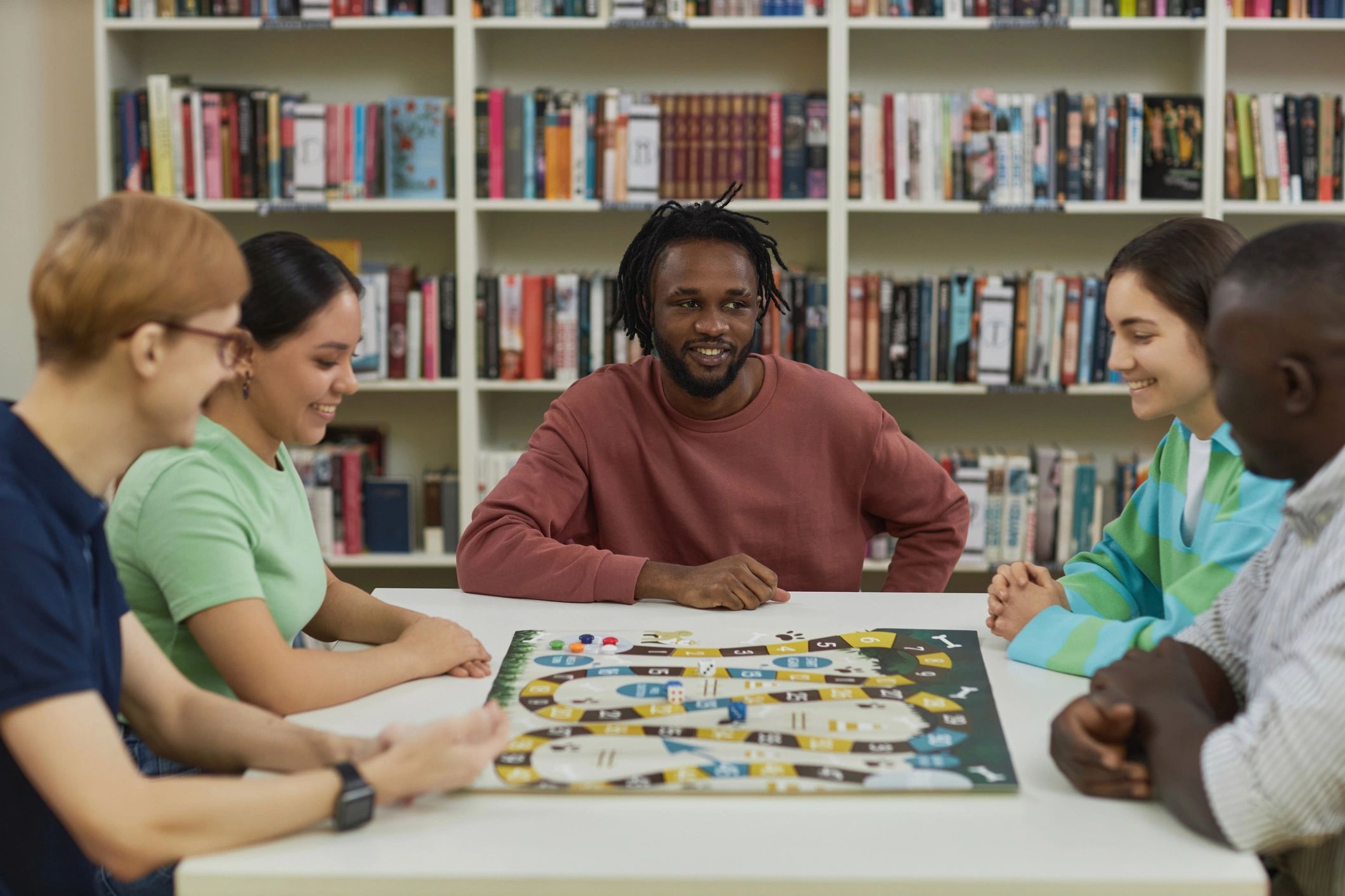 Friends playing board games together at a table