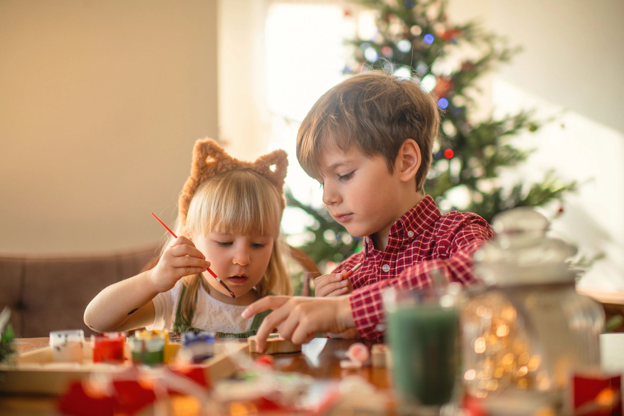 Children doing a holiday craft activity at home