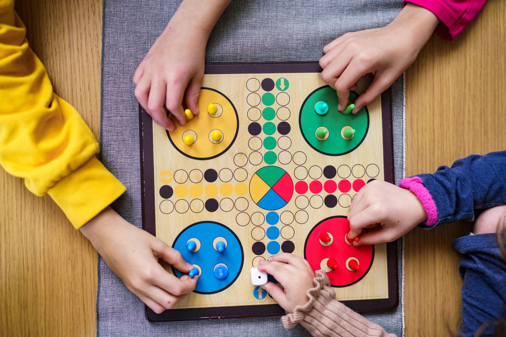 Children’s hands setting up a board game