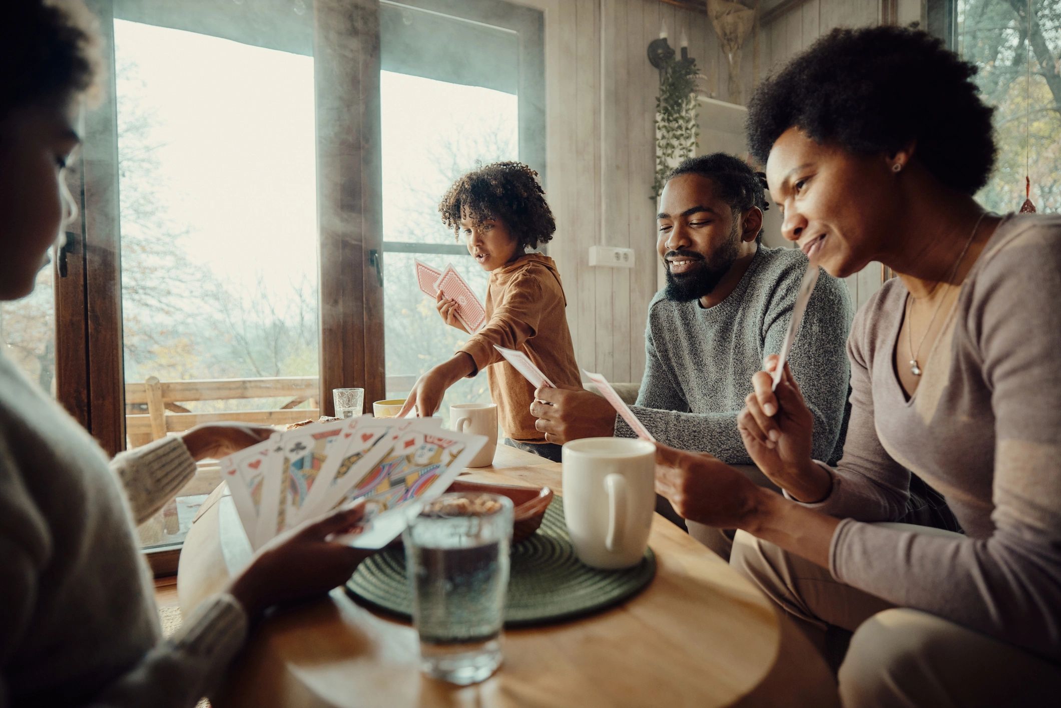 Family playing cards together at home