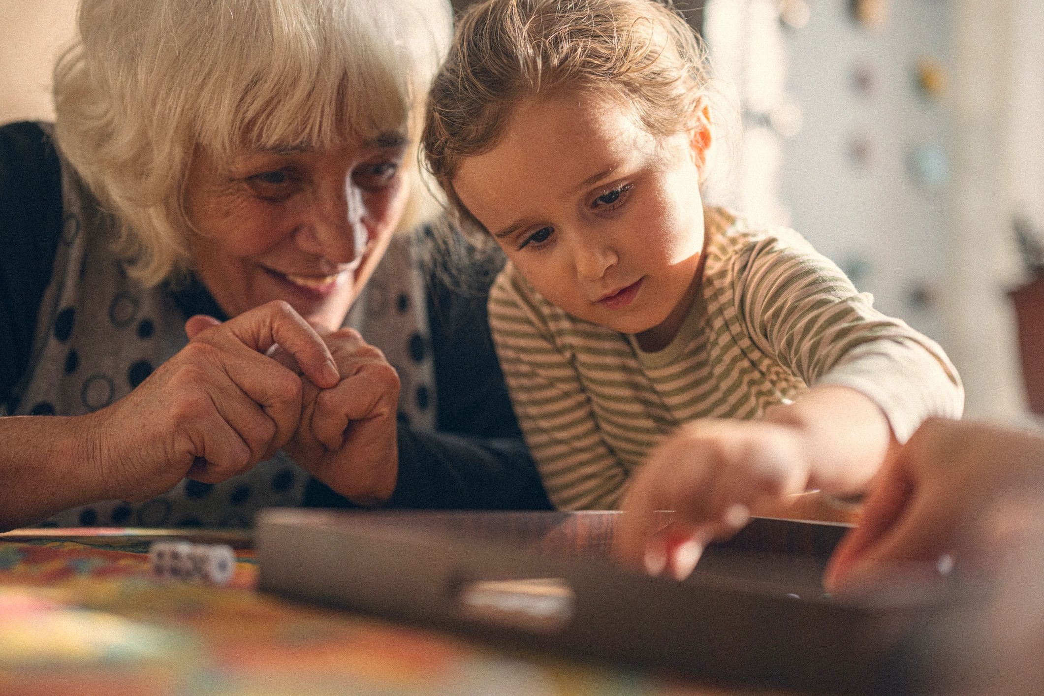 Multigenerational family playing a tabletop game at home
