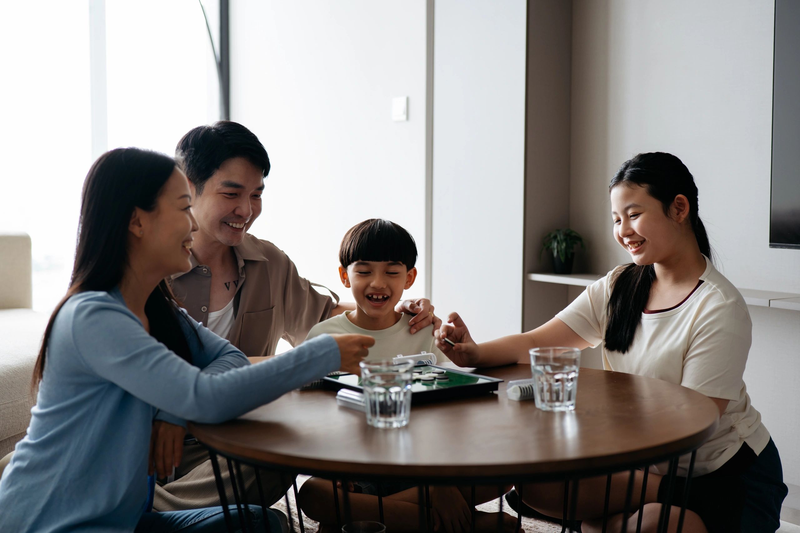 Family playing a board game together at home